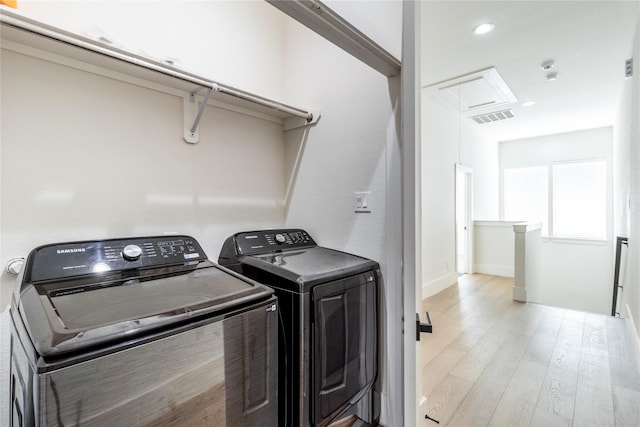 washroom featuring light wood-type flooring and washing machine and clothes dryer