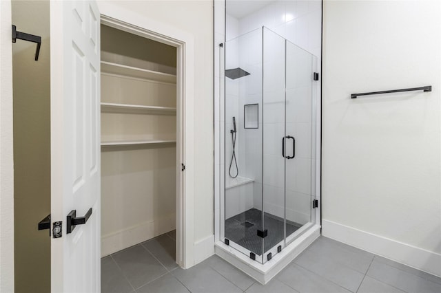 bathroom with tile patterned flooring and a shower with door