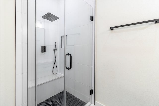 bathroom with a shower with shower door