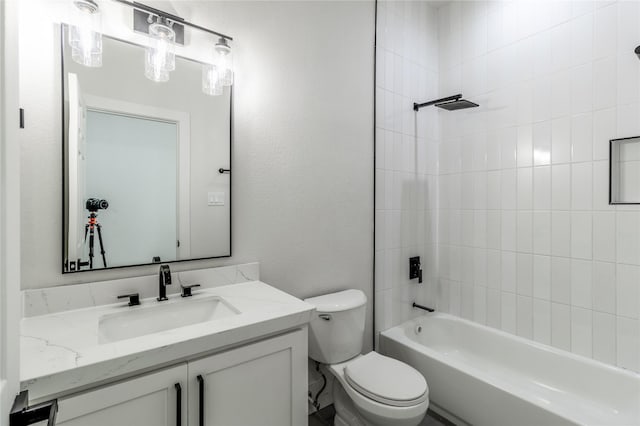 full bathroom with vanity, toilet, and tiled shower / bath