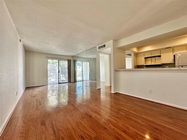 unfurnished living room featuring wood-type flooring