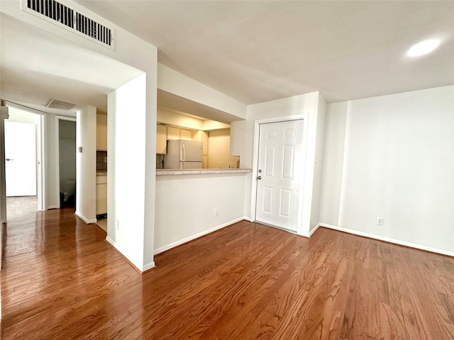 unfurnished living room with hardwood / wood-style flooring