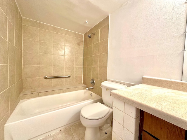 full bathroom featuring tile patterned floors, vanity, tiled shower / bath combo, and toilet