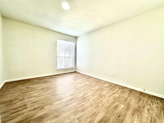 unfurnished room with hardwood / wood-style floors