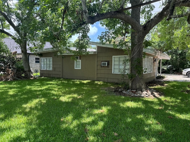 back of house with a lawn