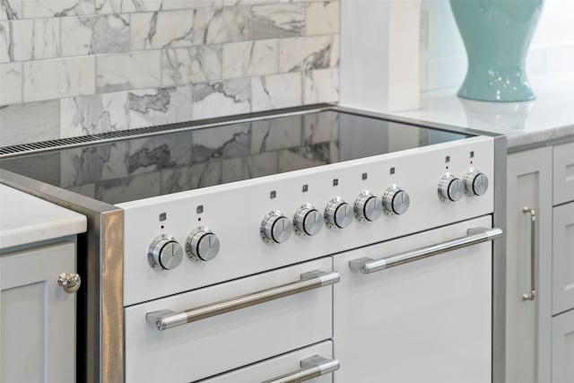 details featuring white cabinets and high end stove