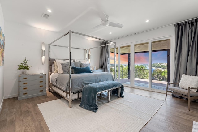 bedroom featuring hardwood / wood-style flooring, ceiling fan, and access to outside