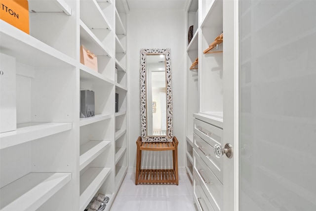 spacious closet with light tile patterned floors