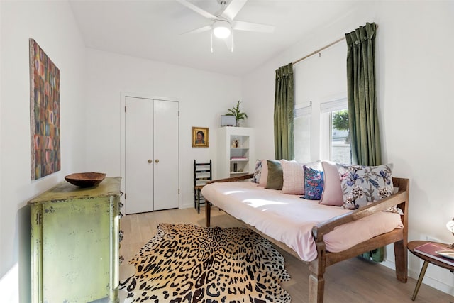 living room featuring light hardwood / wood-style flooring and ceiling fan