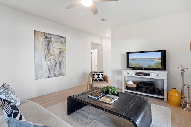 living room featuring hardwood / wood-style flooring and ceiling fan