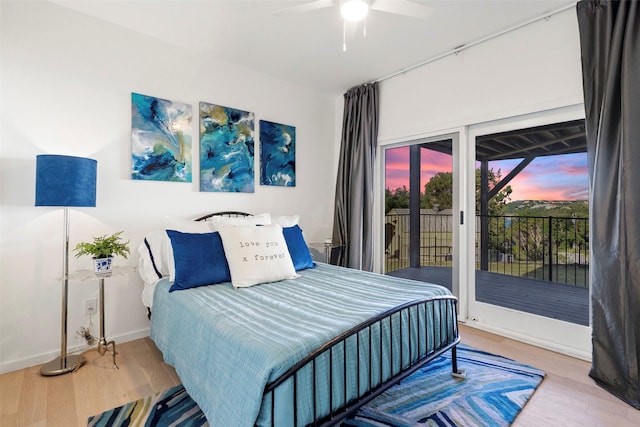 bedroom featuring ceiling fan, access to exterior, and wood-type flooring