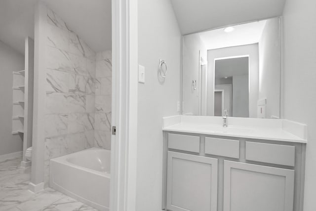 full bathroom featuring vanity, tiled shower / bath combo, and toilet