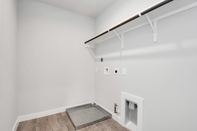 washroom with hookup for a gas dryer, hookup for a washing machine, hardwood / wood-style flooring, and hookup for an electric dryer