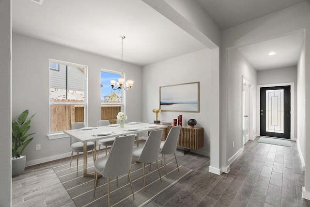 dining room with a chandelier, wood finished floors, baseboards, and recessed lighting