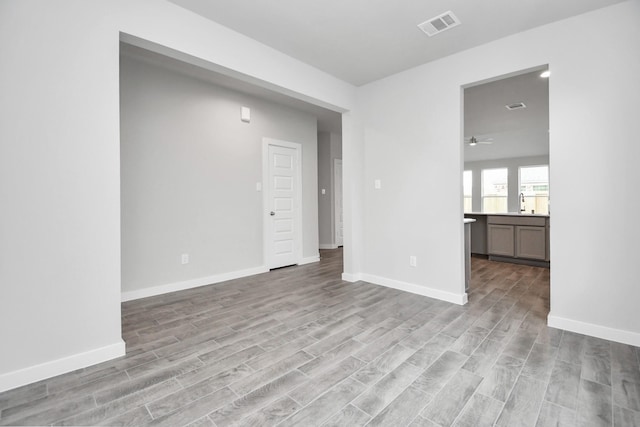 spare room with light hardwood / wood-style floors and ceiling fan