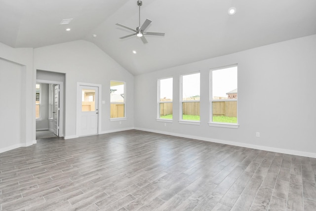 unfurnished living room featuring ceiling fan, high vaulted ceiling, and light hardwood / wood-style floors