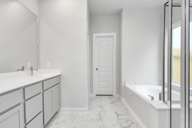 bathroom featuring a bathing tub, plenty of natural light, and vanity