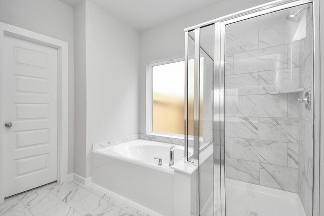 full bath featuring a bath, a shower stall, and marble finish floor