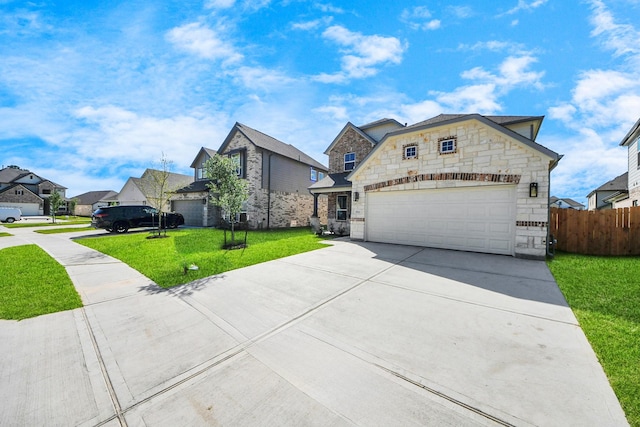 view of front of home with fence, a residential view, driveway, stone siding, and a front yard