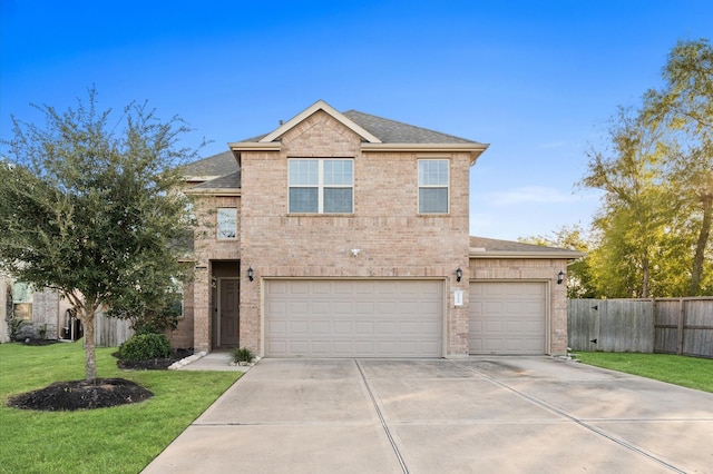 view of front of property featuring a garage and a front lawn