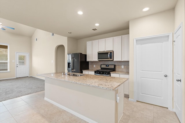 kitchen featuring sink, a kitchen island with sink, stainless steel appliances, decorative backsplash, and white cabinets