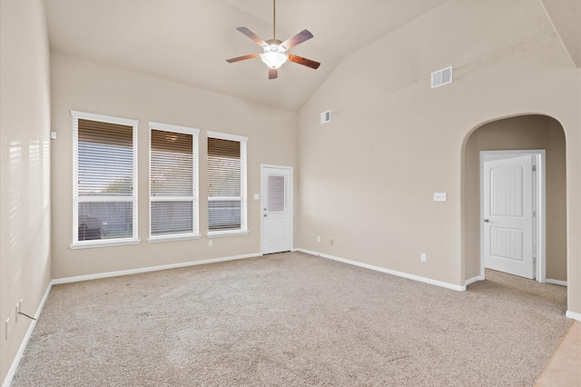 carpeted empty room featuring ceiling fan and high vaulted ceiling