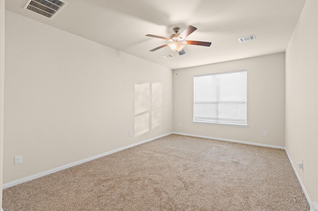 empty room with ceiling fan and light colored carpet