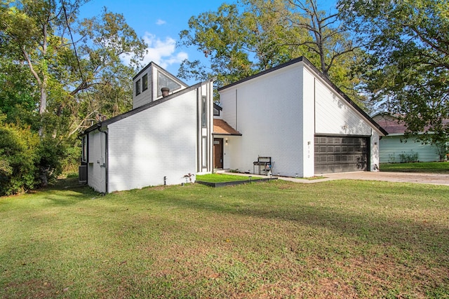 exterior space featuring a front lawn and a garage