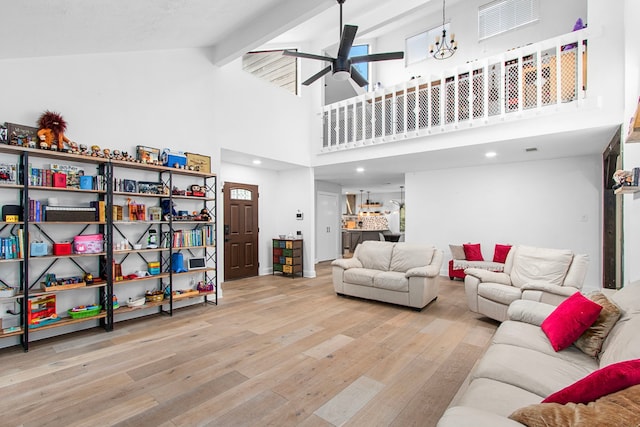 living room featuring beam ceiling, ceiling fan, high vaulted ceiling, and light hardwood / wood-style floors