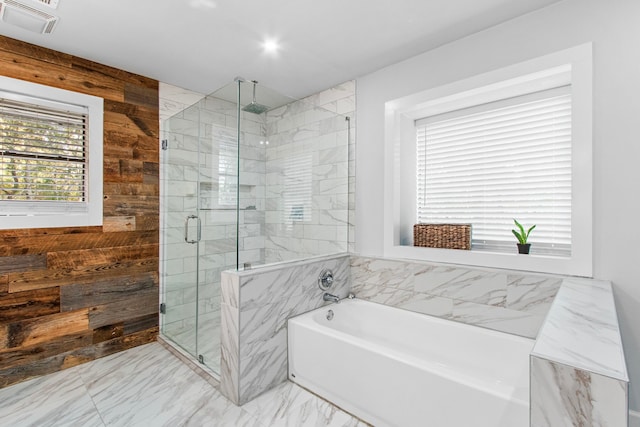 bathroom with wooden walls and independent shower and bath