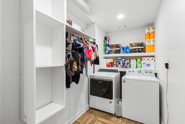 laundry area with washer and dryer and light parquet floors