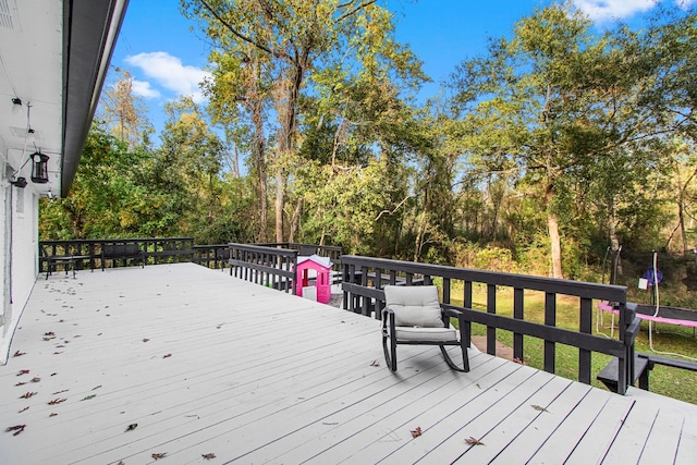 wooden terrace with a trampoline