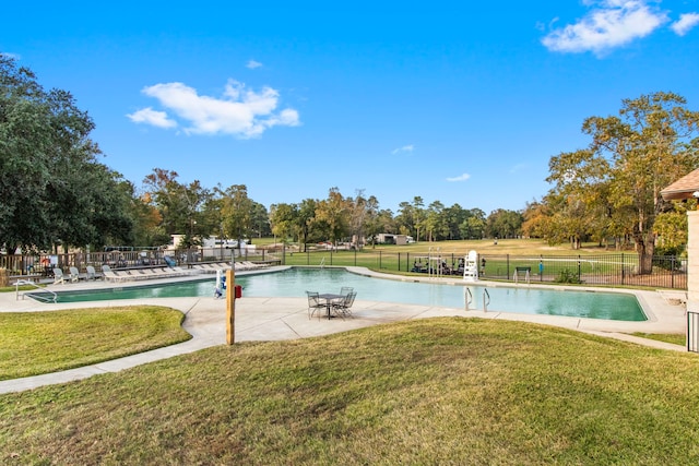 view of swimming pool with a lawn and a patio area