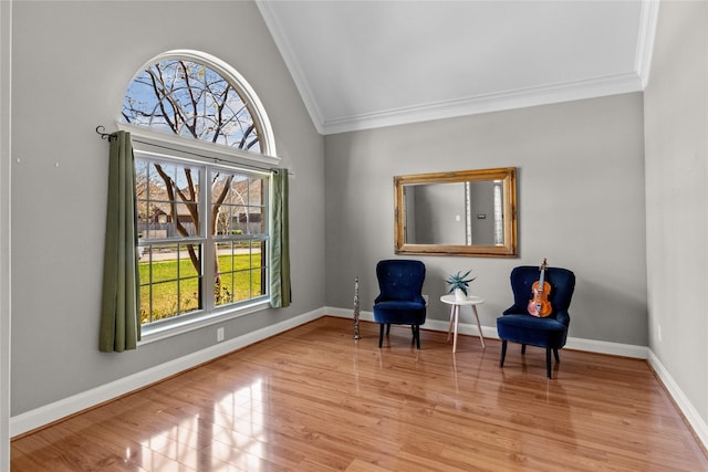 sitting room with vaulted ceiling, light hardwood / wood-style flooring, and crown molding