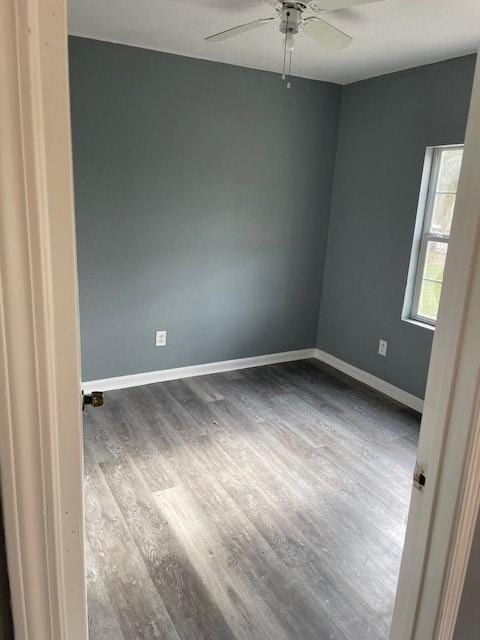 spare room with wood-type flooring and ceiling fan