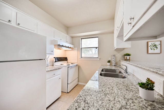 kitchen with white cabinetry, sink, light stone countertops, and white appliances