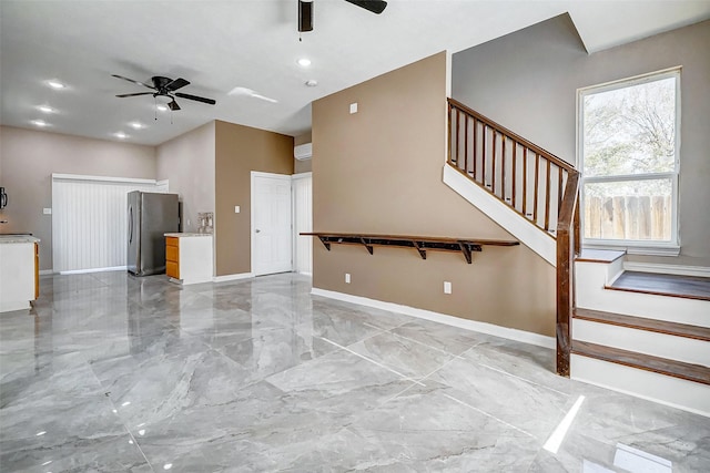 unfurnished living room with ceiling fan