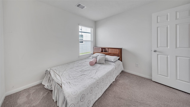 bedroom featuring light colored carpet