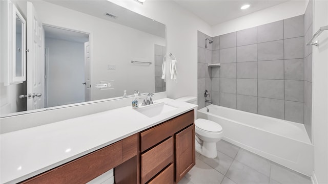 full bathroom featuring tile patterned floors, vanity, toilet, and tiled shower / bath