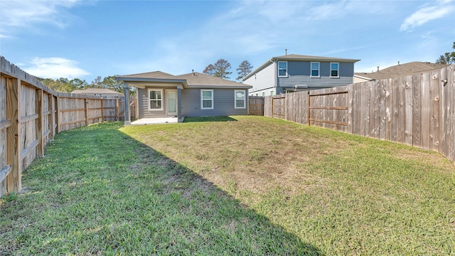 back of house with a lawn and a patio area