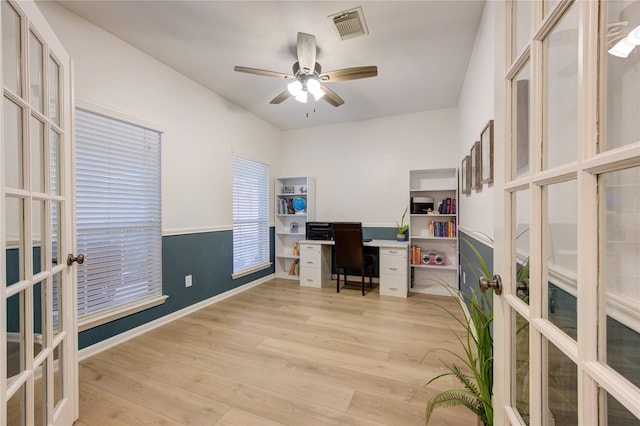 office space featuring ceiling fan, french doors, and light hardwood / wood-style flooring