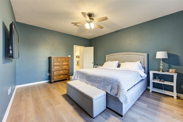 bedroom with light hardwood / wood-style floors and ceiling fan