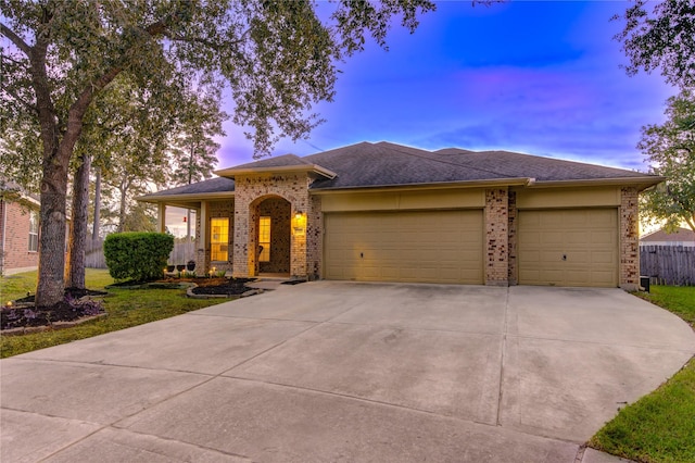 view of front facade with a lawn and a garage