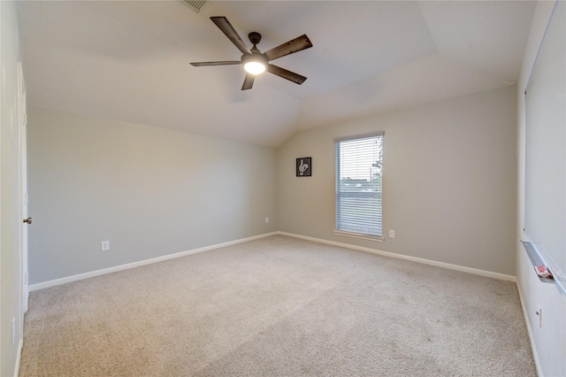 carpeted empty room featuring ceiling fan and lofted ceiling