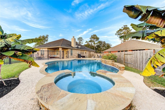 view of pool with an in ground hot tub