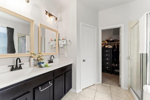 bathroom featuring tile patterned flooring, vanity, and walk in shower