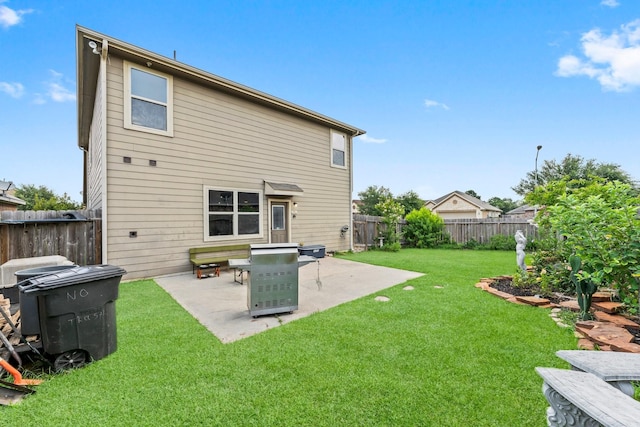 back of property featuring a yard and a patio area