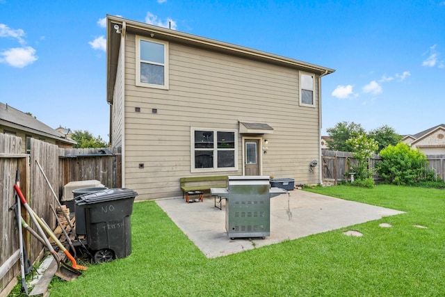 rear view of property featuring a lawn and a patio area