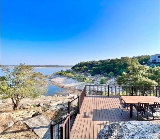 wooden deck featuring a water view