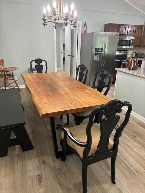 dining room featuring a chandelier and light hardwood / wood-style flooring